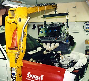 Hoisting the new engine into the car