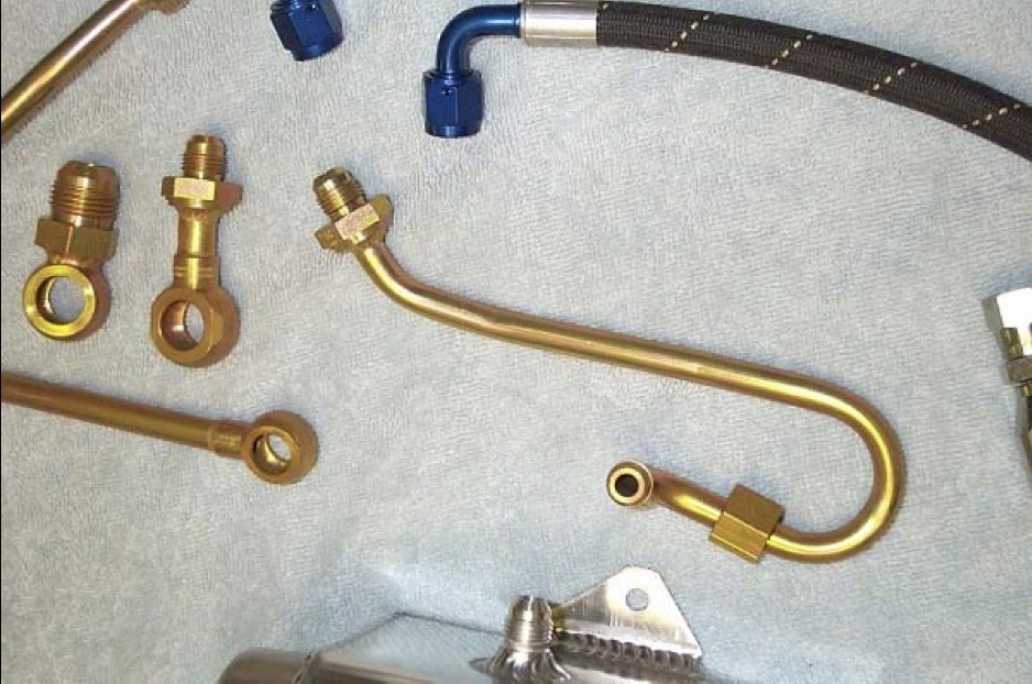 closeup of some of the new power steering lines with AN fittings welded on